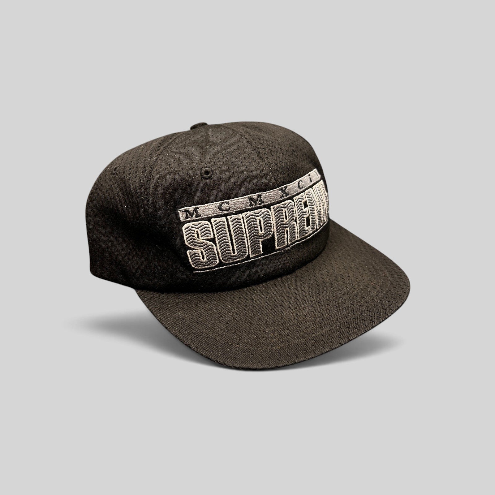Raree Finds vintage black Supreme MCMXCIV mesh snapback hat with 3D white embroidered logo and adjustable closure.