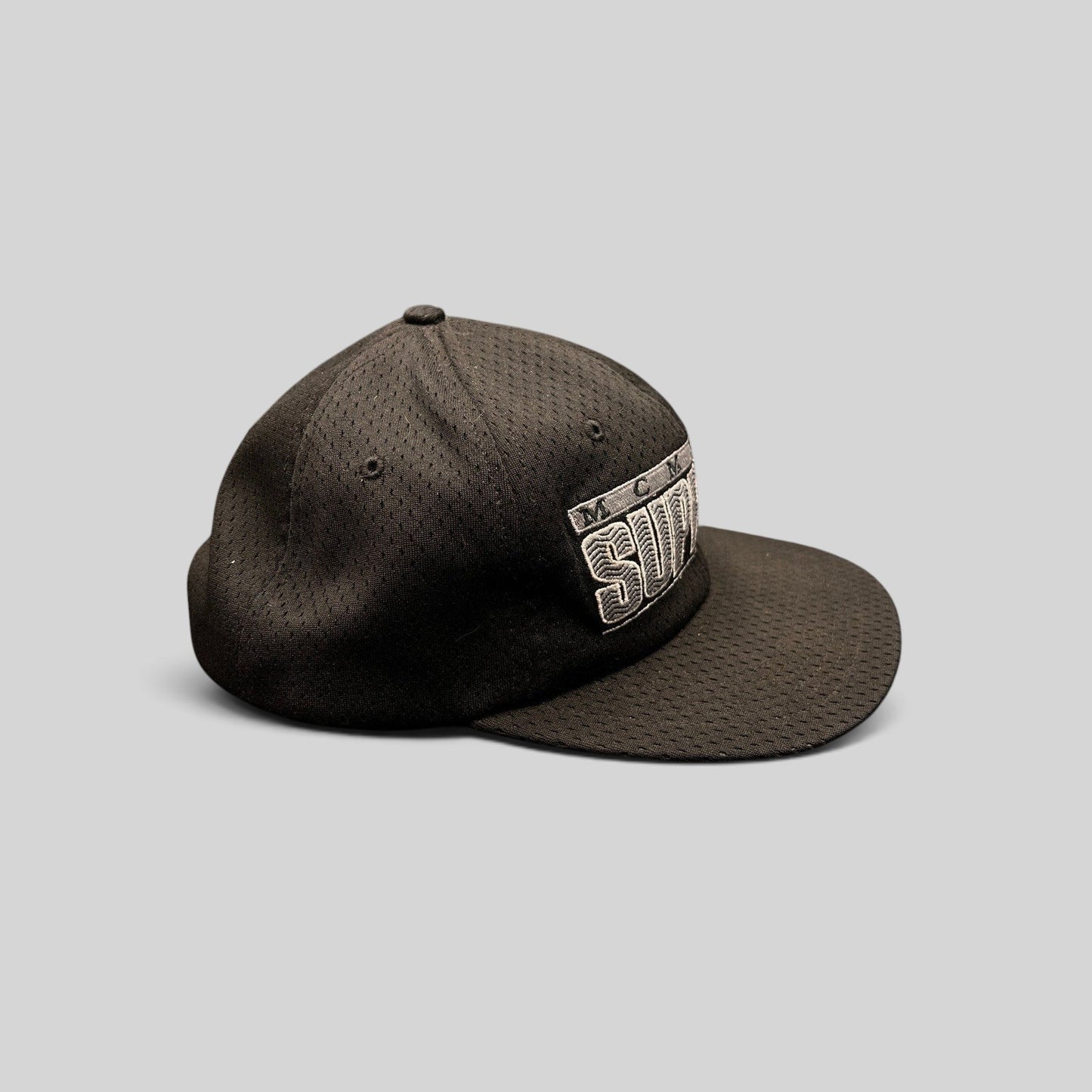 Raree Finds vintage black Supreme MCMXCIV mesh snapback hat with 3D raised embroidery, side profile view.