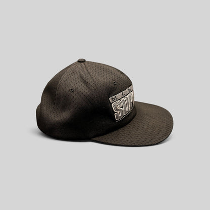 Raree Finds vintage black Supreme MCMXCIV mesh snapback hat with 3D raised embroidery, side profile view.