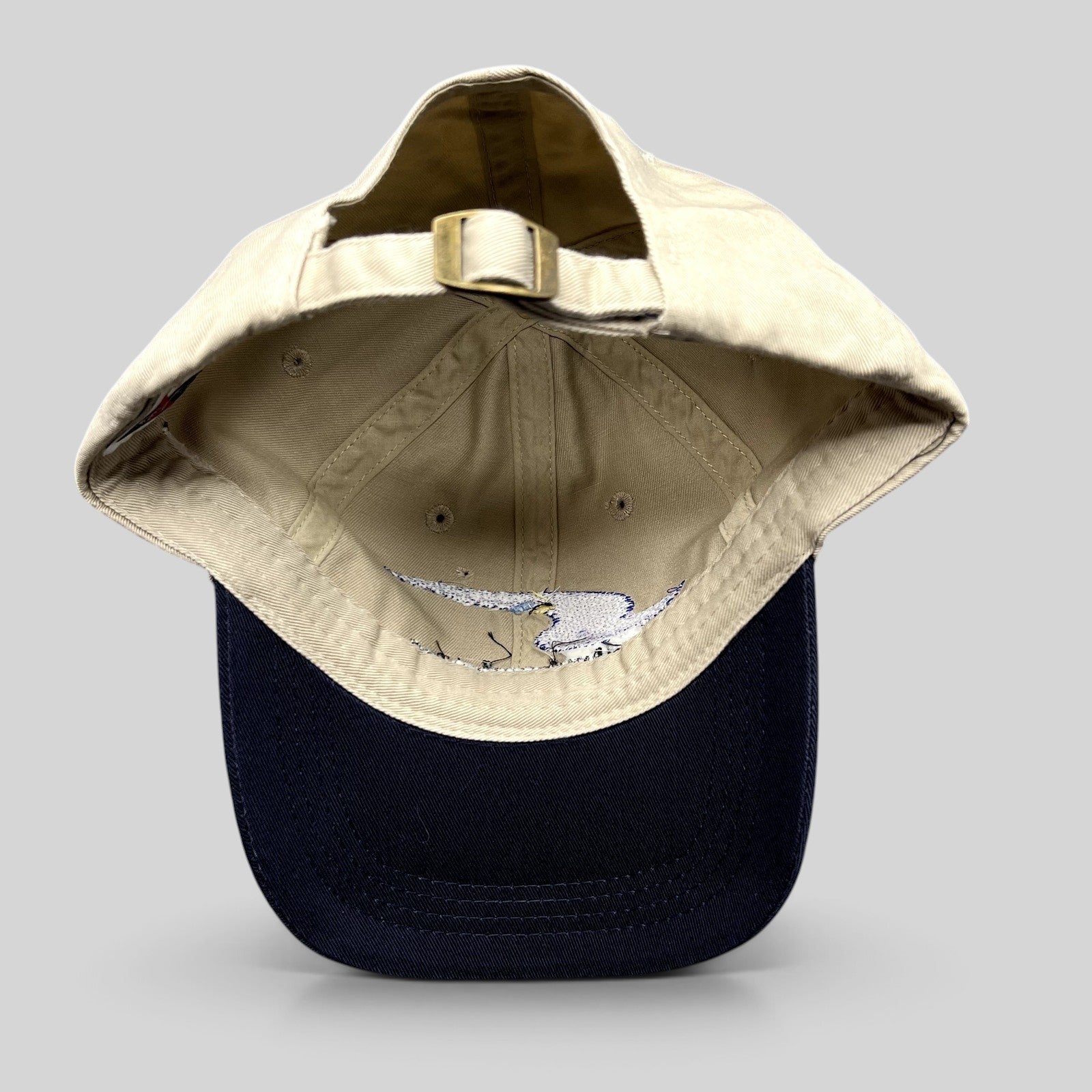 Raree Finds vintage Swift Engineering Inc two-tone khaki and navy cotton strapback hat with brass buckle closure