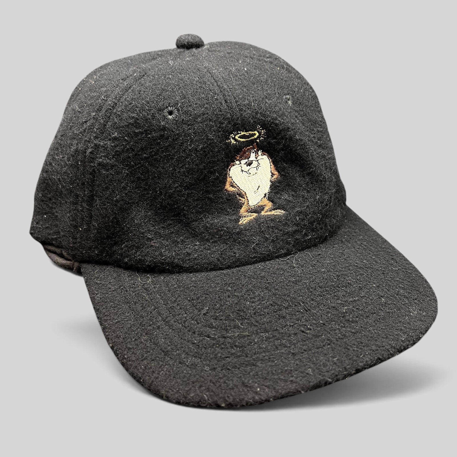 Raree Finds vintage 1995 black wool snapback hat featuring an embroidered Tasmanian Devil Taz character with a halo.