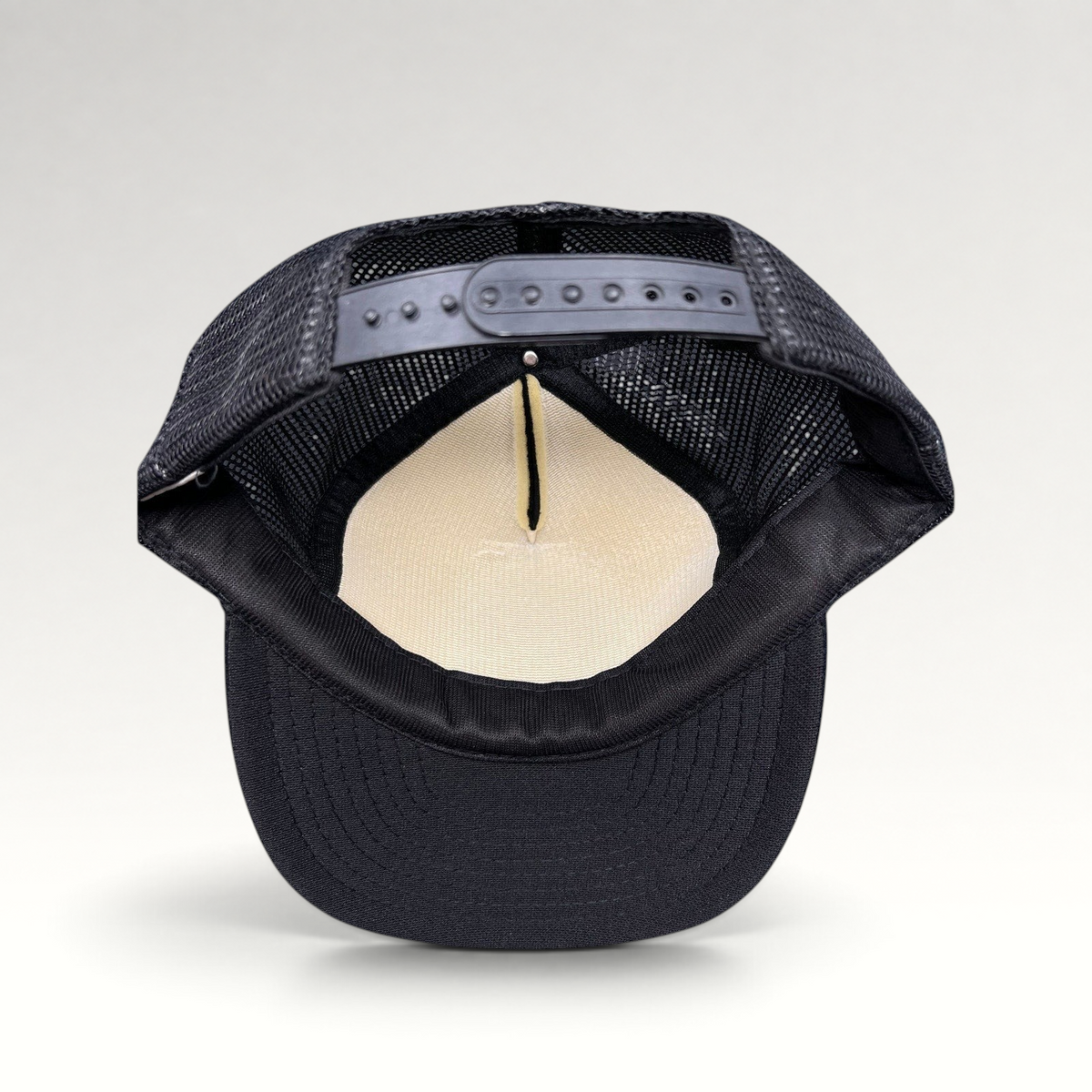 Raree Finds vintage 1989 The Who trucker hat interior view showing black mesh back, foam lining, and snapback closure.