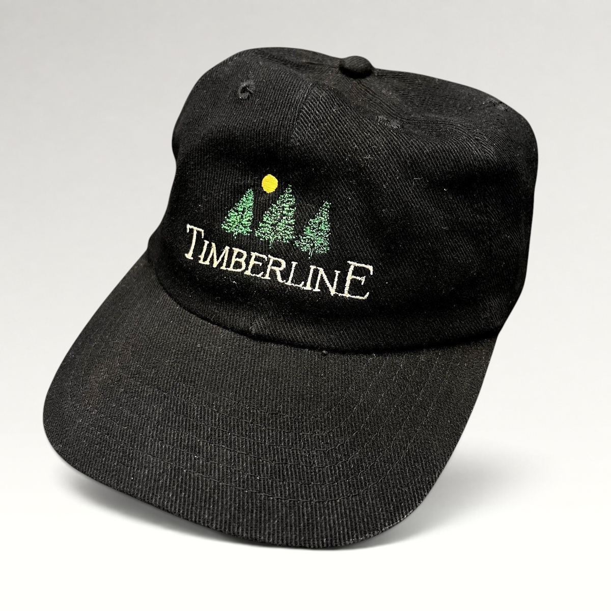 Raree Finds vintage 1990s black Timberline strapback hat with embroidered tree logo and yellow sun detail