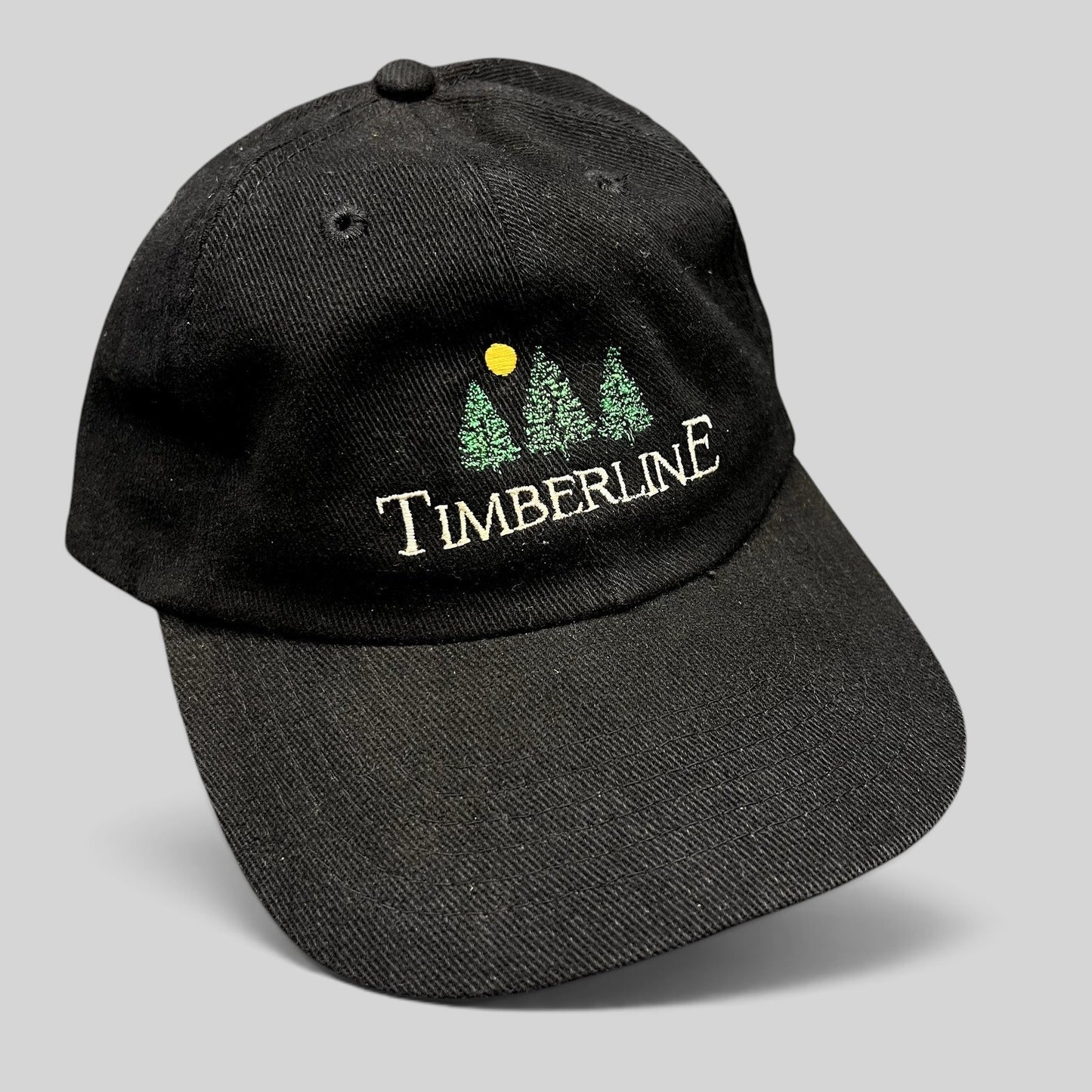 Raree Finds vintage 1990s black Timberline strapback dad hat with embroidered green pine trees and yellow sun logo