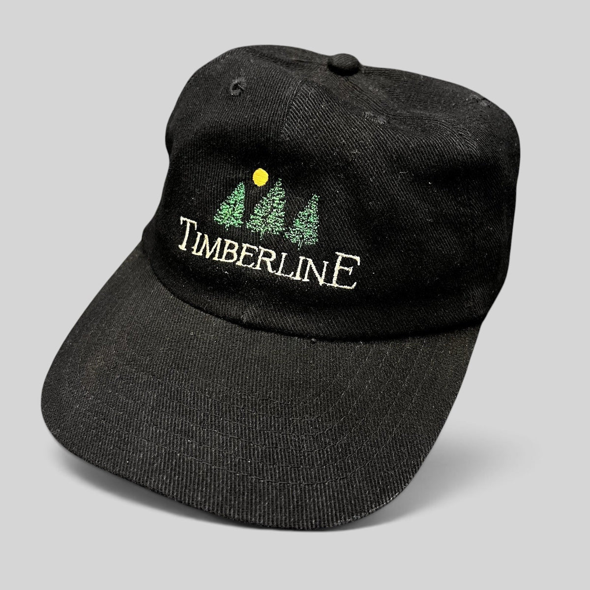 Raree Finds vintage 1990s black Timberline strapback dad hat with embroidered tree logo and restaurant branding