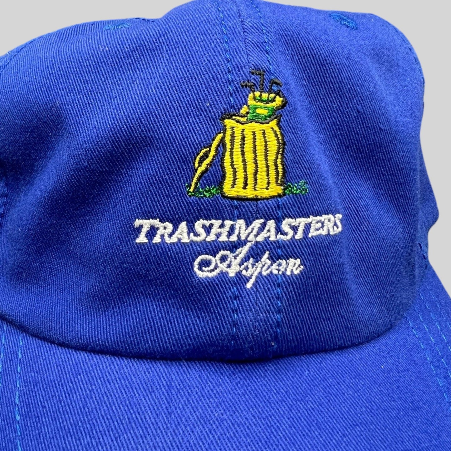 Raree Finds vintage royal blue cotton Trashmasters Aspen golf hat with embroidered yellow trash can and club logo.
