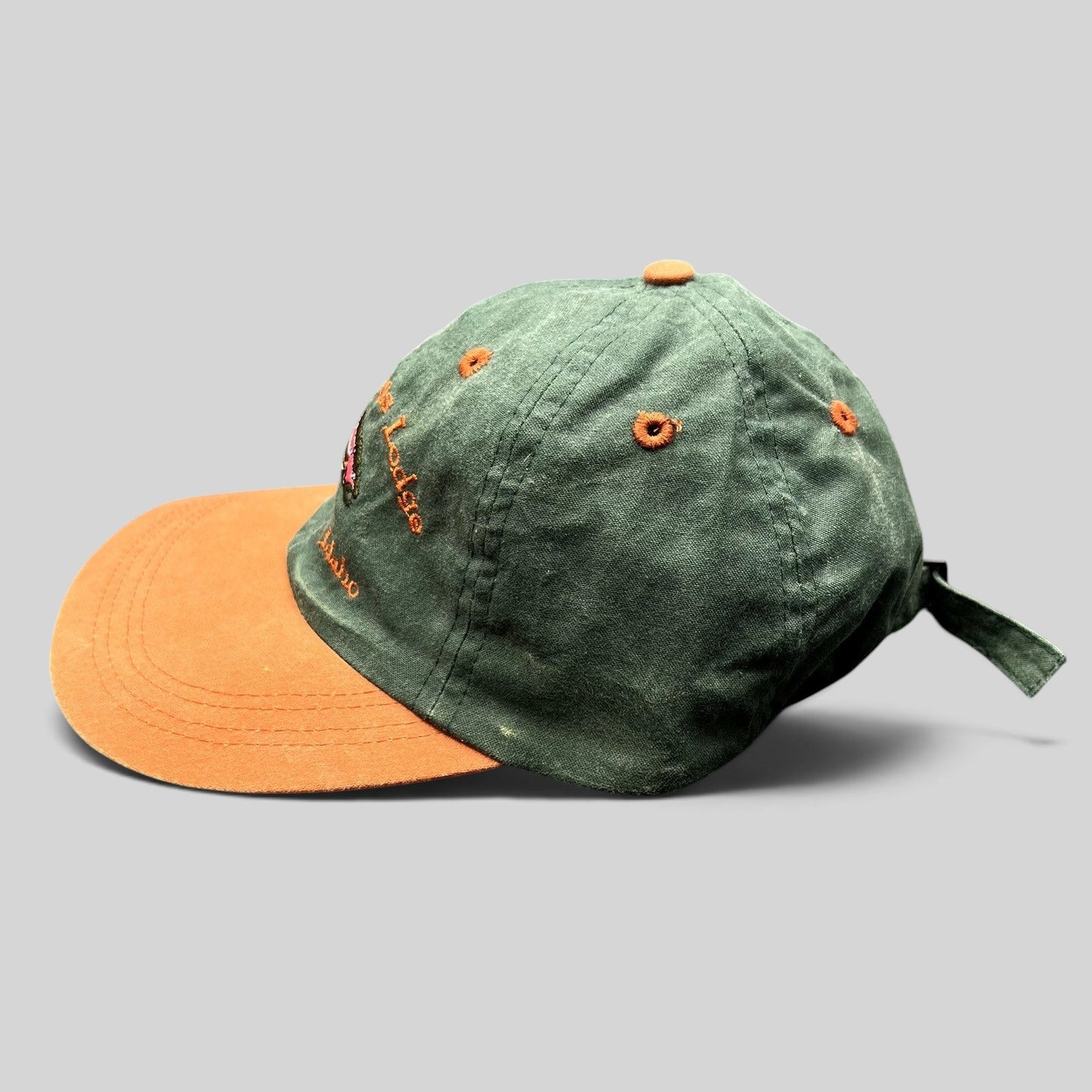 Raree Finds vintage Staley Springs Lodge two-tone green and brown fishing strapback hat with embroidered trout design.