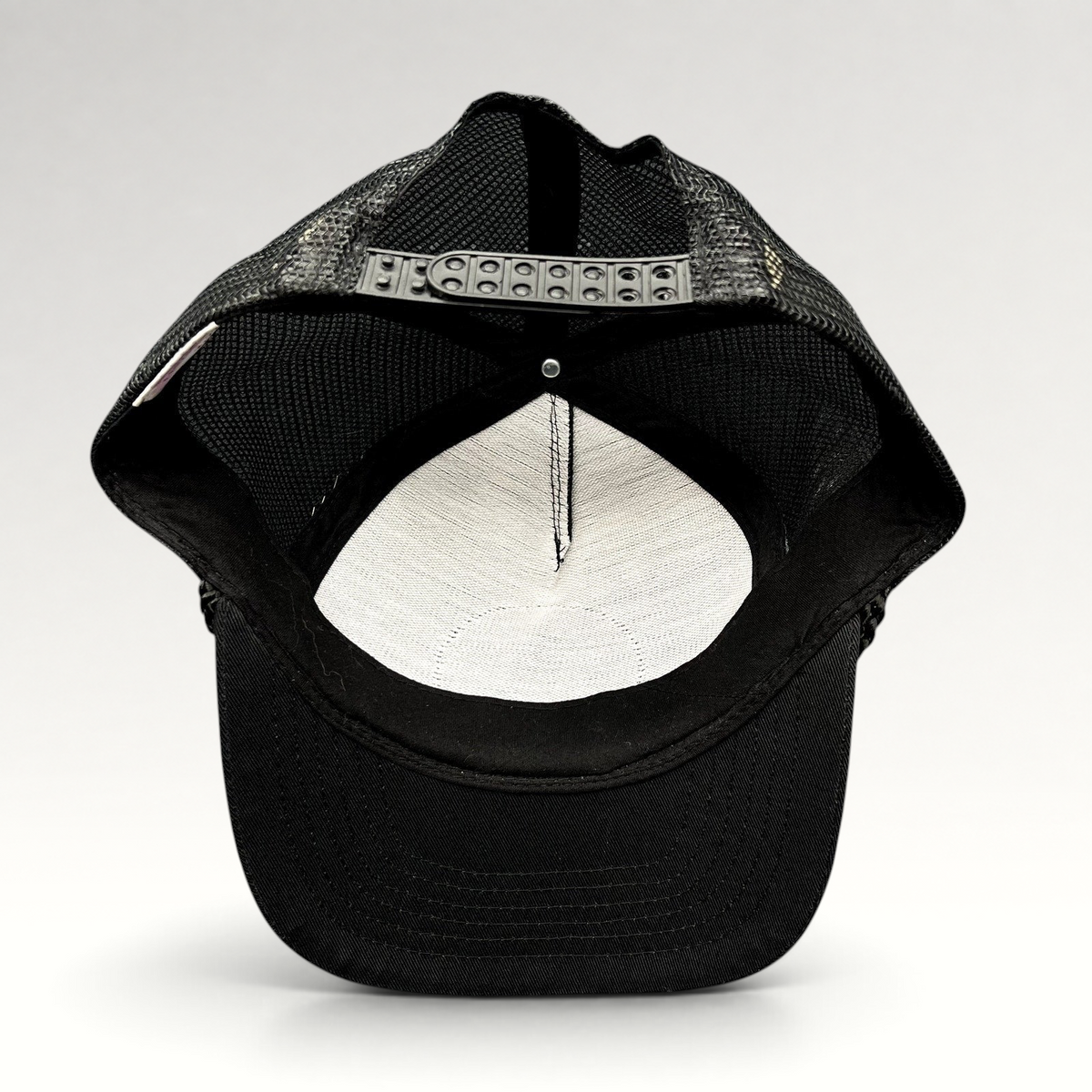 Raree Finds vintage Calistoga Wine trucker hat showing the black mesh back and adjustable plastic snapback closure