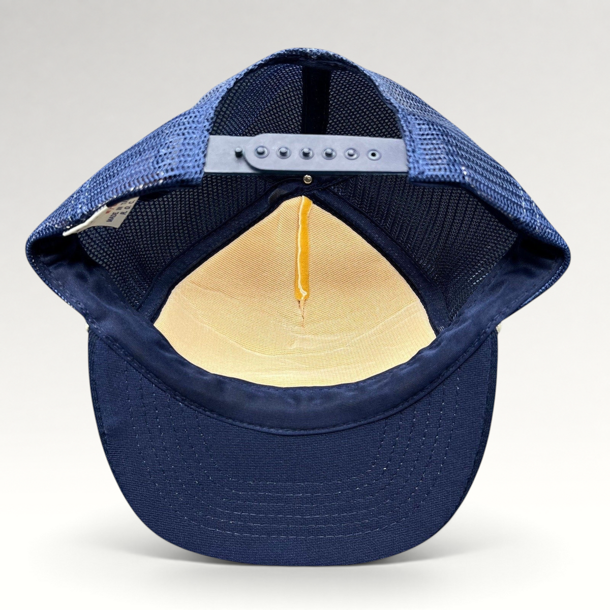 Raree Finds vintage Beverly Hills Gun Club trucker hat interior showing navy mesh back, snapback, and foam crown.