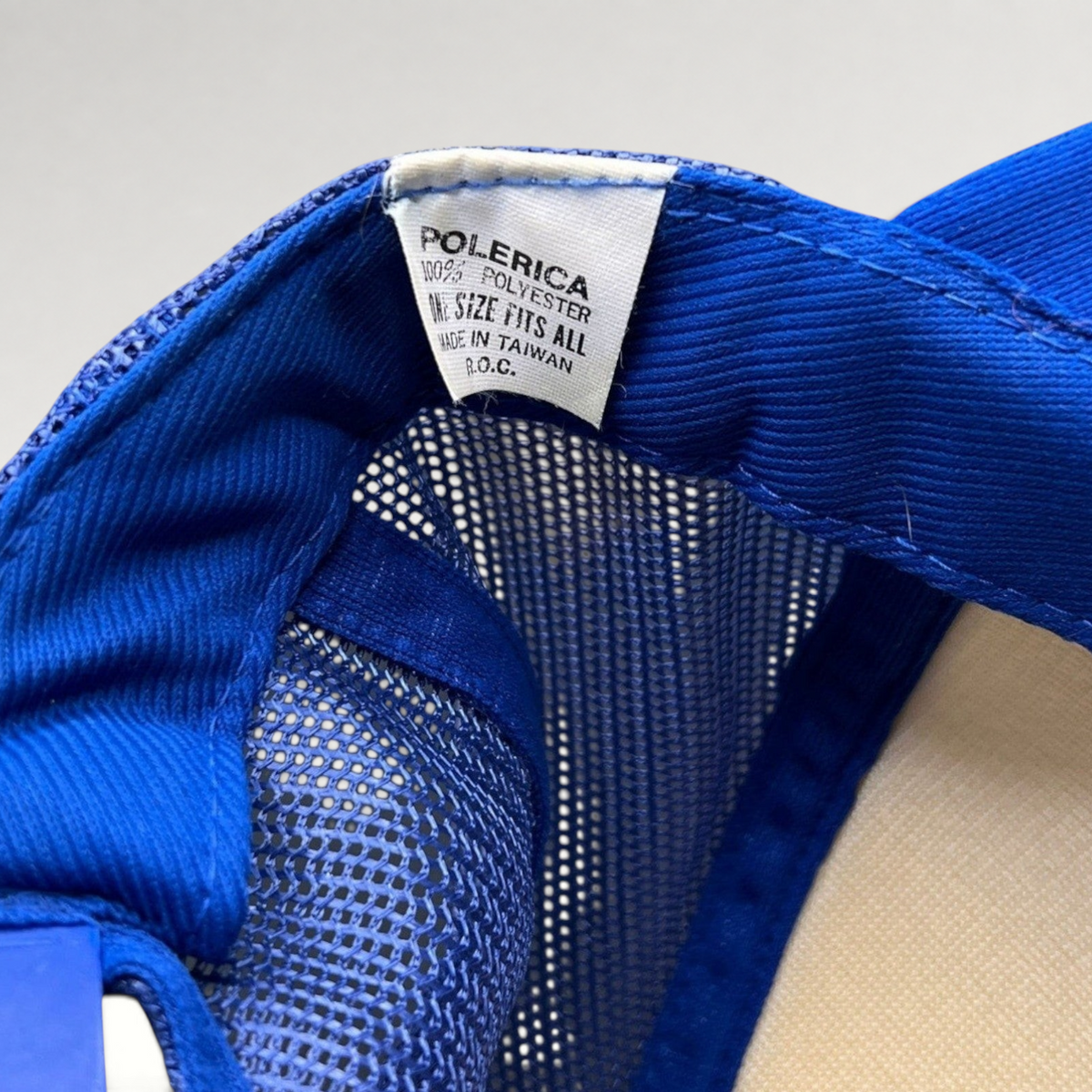 Raree Finds vintage trucker hat interior label showing Polerica branding, polyester material, and Taiwan origin