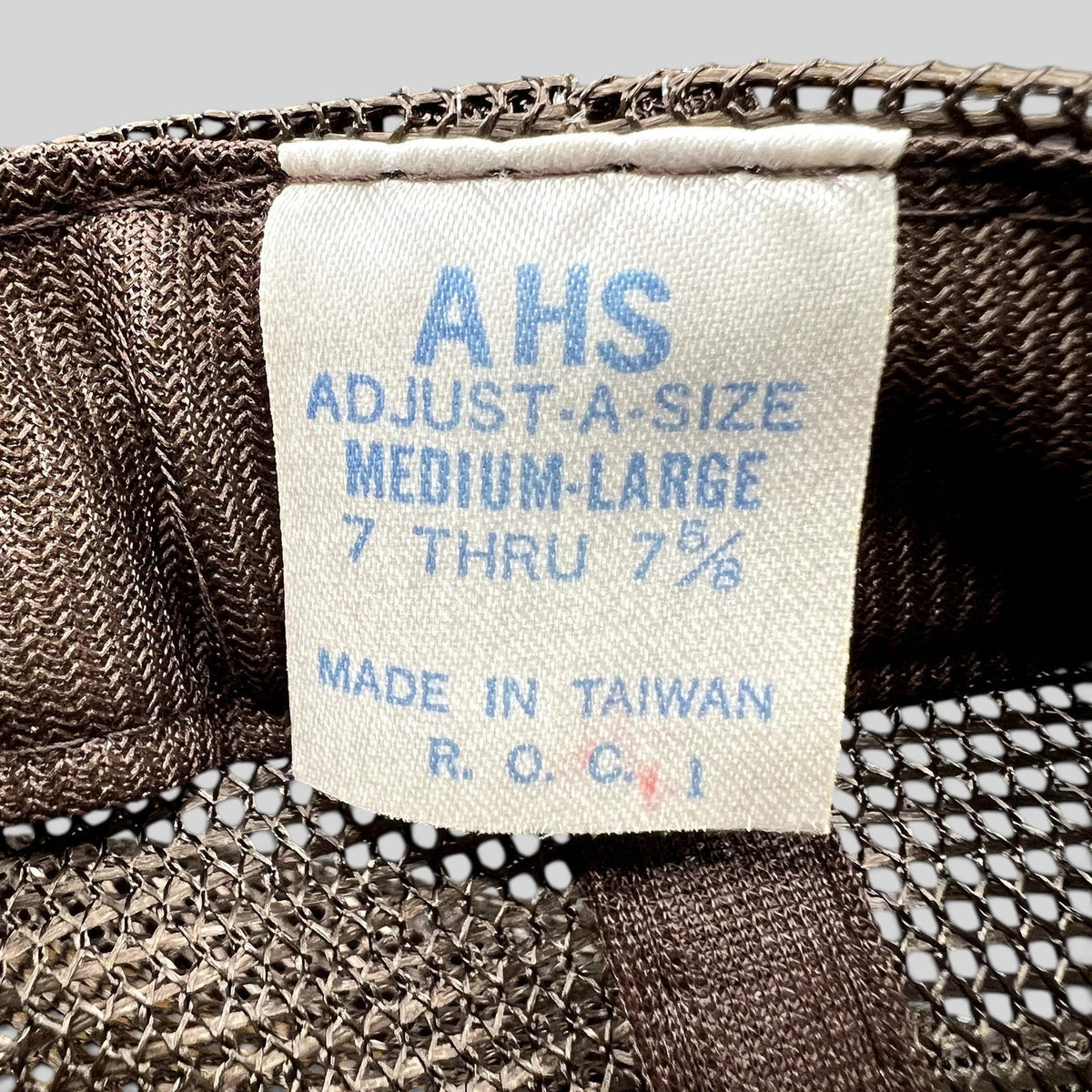 Raree Finds vintage AHS Adjust-A-Size trucker hat interior label showing size and manufacturing details