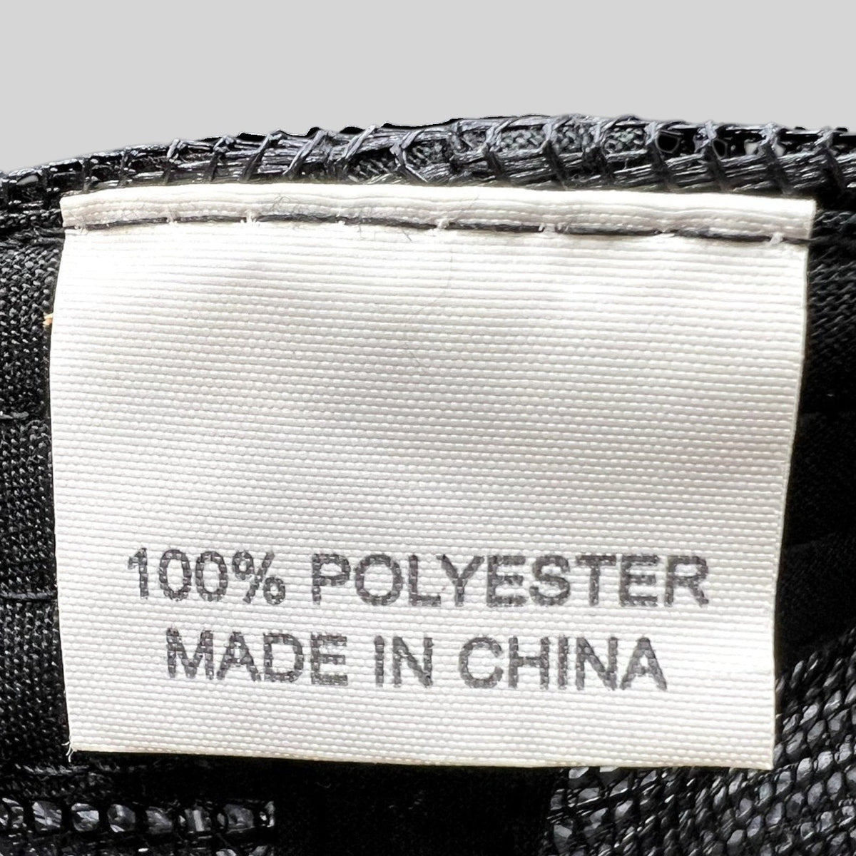 Raree Finds vintage trucker hat interior care label showing 100% polyester material and made in China origin
