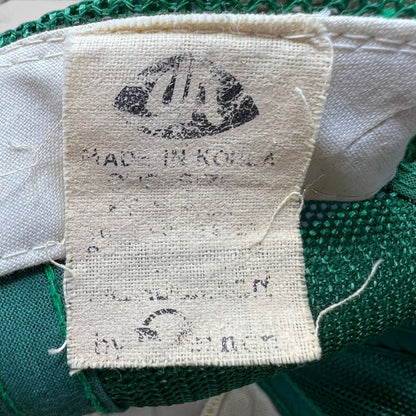 Raree Finds vintage Young An trucker hat interior fabric tag showing Made in Korea branding against green mesh