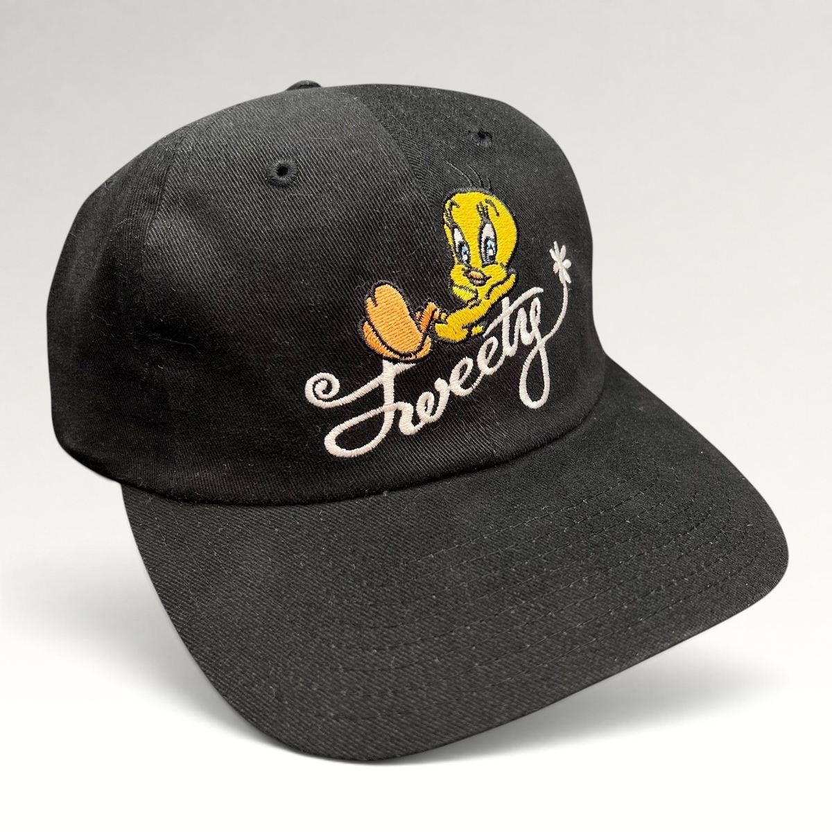 Raree Finds vintage 1998 Warner Bros Studio Store black cotton strapback hat with embroidered Tweety Bird logo