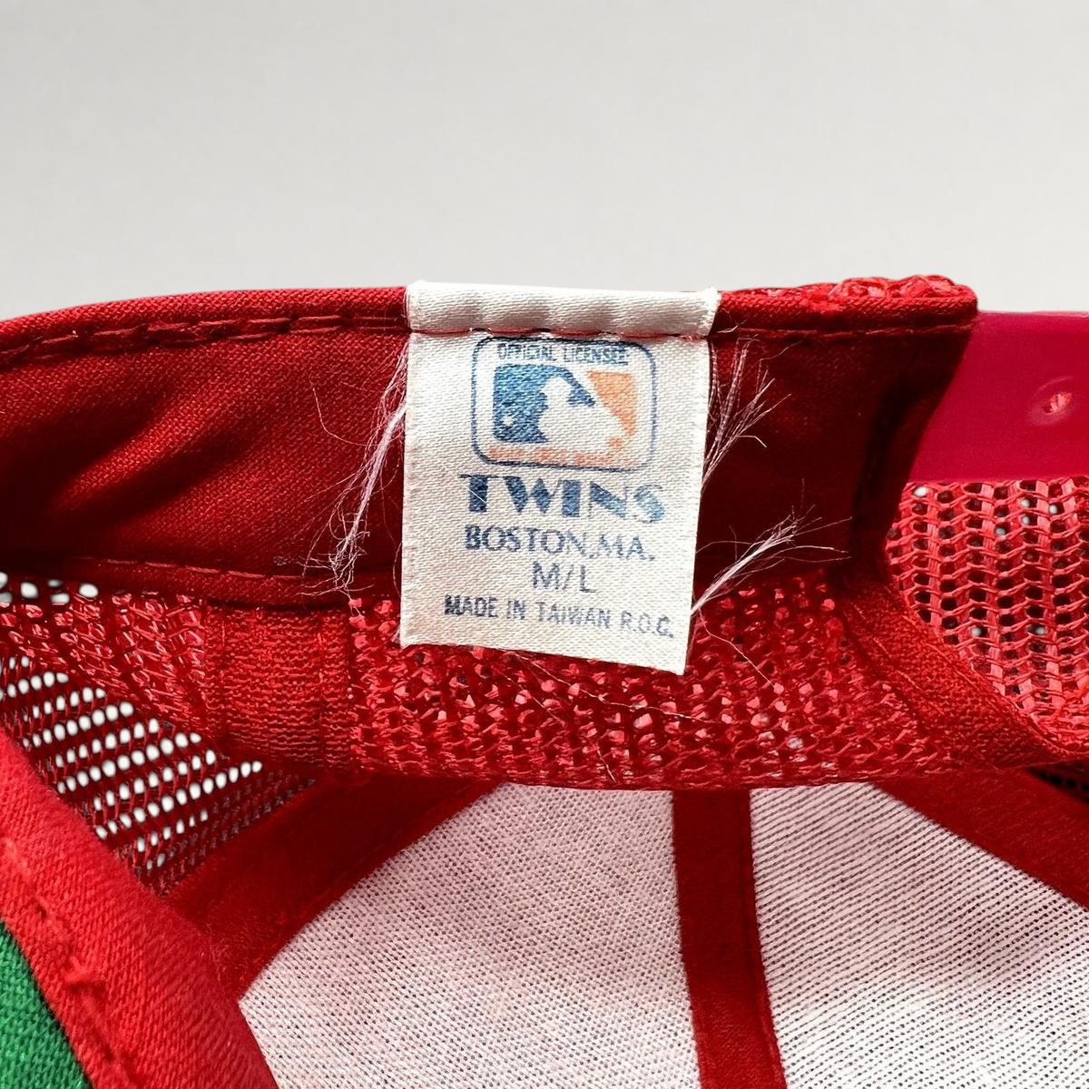 Raree Finds vintage Twins Enterprise MLB hat label showing official licensing and Made in Taiwan origin on red mesh