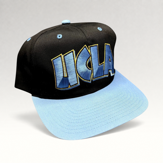 Raree Finds vintage 90s UCLA Bruins snapback hat with black crown, powder blue brim, and oversized UCLA embroidery.