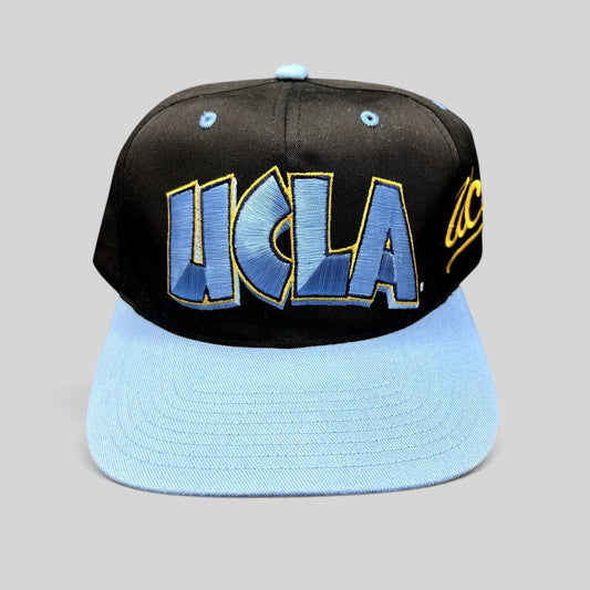 Raree Finds vintage UCLA Bruins snapback hat with black crown, powder blue brim, and oversized embroidered logo.
