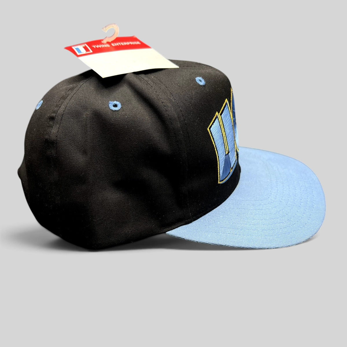 Raree Finds vintage UCLA Bruins snapback hat in black and powder blue with oversized embroidered logo and tag
