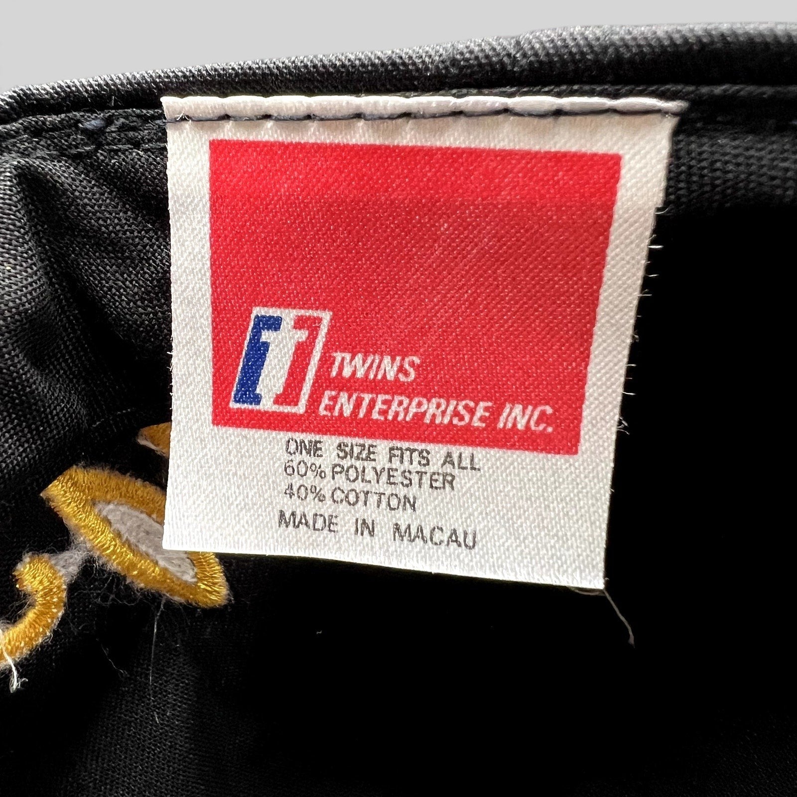Raree Finds vintage Twins Enterprise UCLA hat interior tag showing material composition and Macau origin