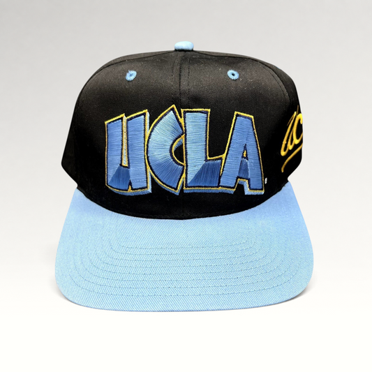 Raree Finds vintage 90s UCLA Bruins snapback hat with black crown, powder blue brim, and oversized UCLA embroidery.