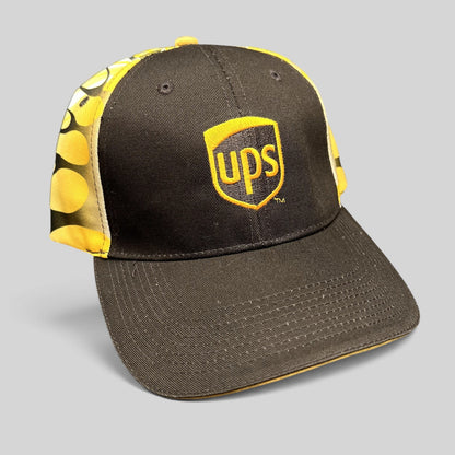 Raree Finds vintage brown and yellow UPS strapback hat with embroidered shield logo and flame side panel graphics.
