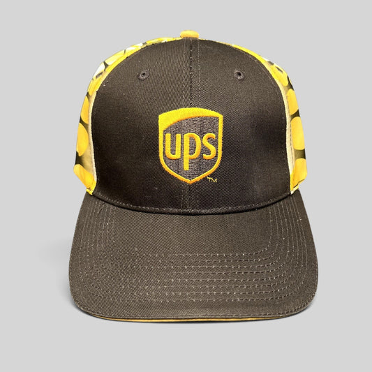 Raree Finds vintage brown and yellow UPS strapback hat with embroidered shield logo and flame side panel graphics.