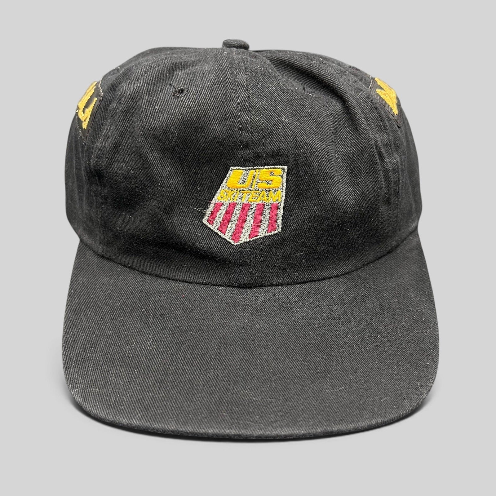 Raree Finds vintage 90s USA Ski Team black snapback hat with red, white, and gold embroidered shield logo