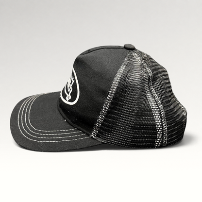 Raree Finds vintage Von Dutch black and white trucker hat with embroidered logo, mesh back, and contrast stitching.