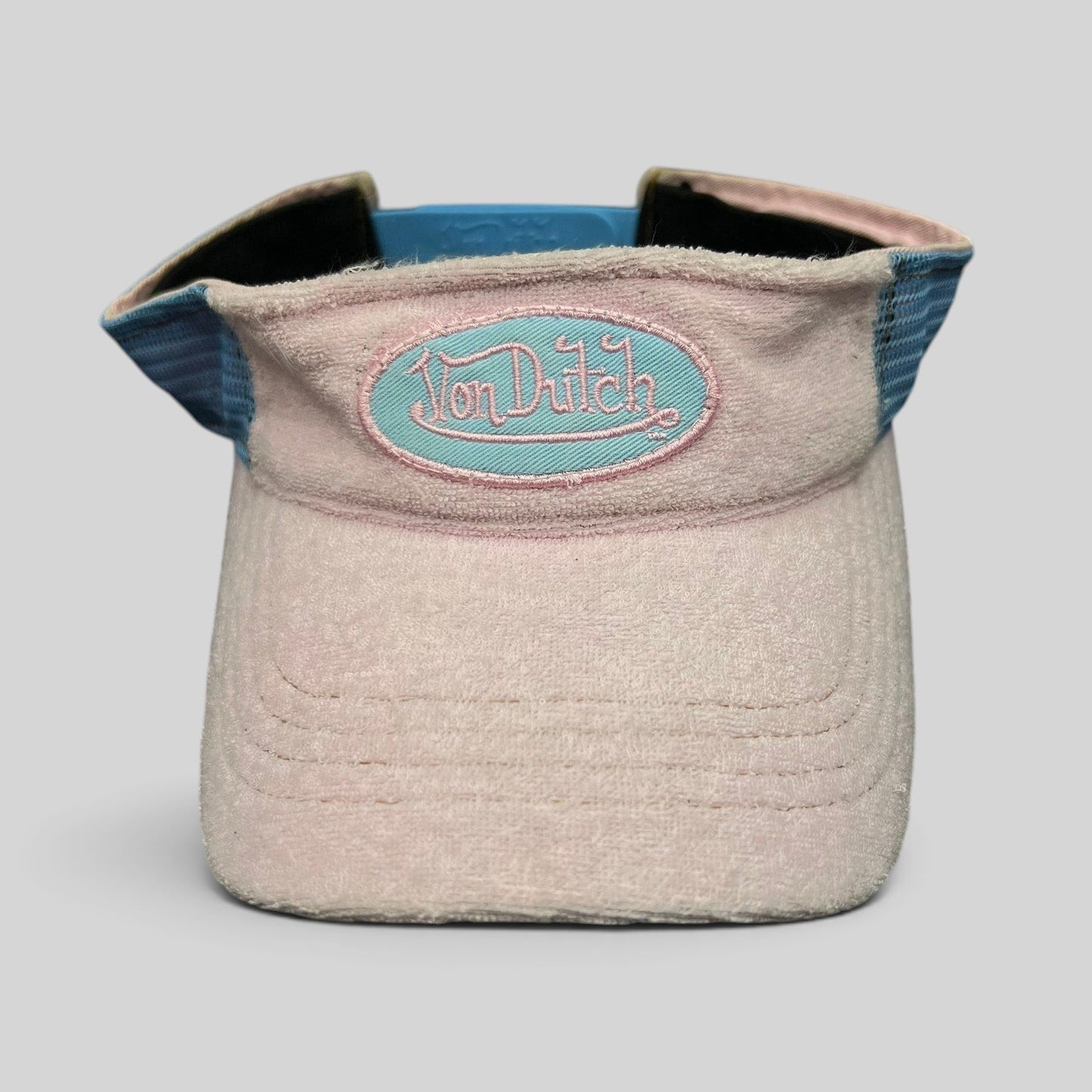 Raree Finds vintage pink and blue Von Dutch terry cloth visor with an oval logo patch and adjustable strapback closure.