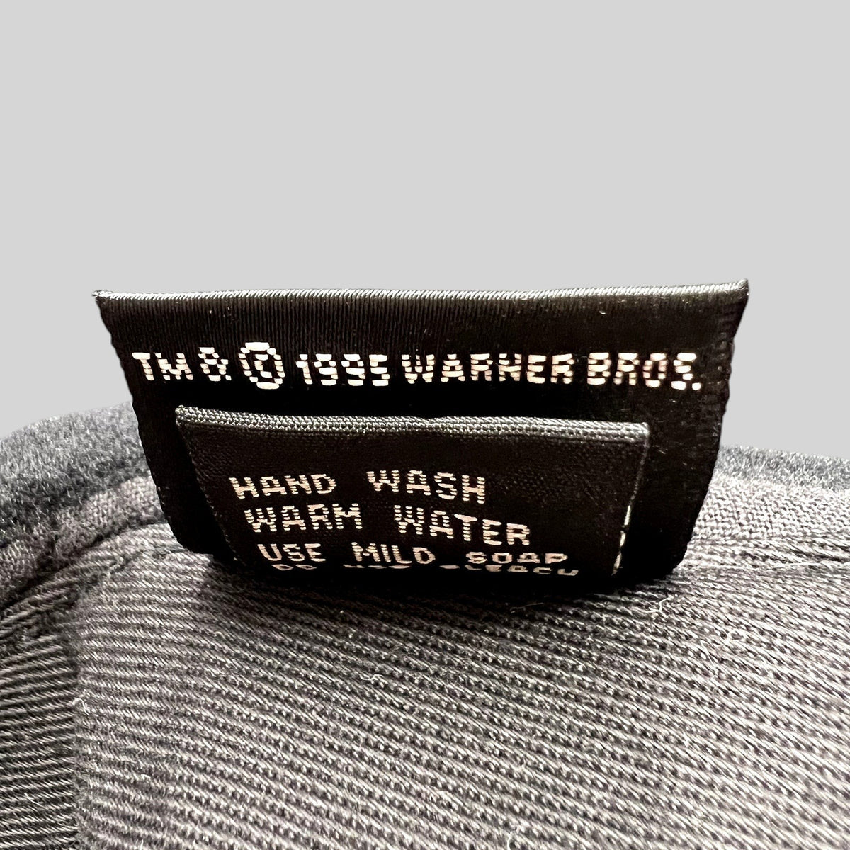 Raree Finds vintage 1995 Warner Bros wool hat interior care tag with washing instructions