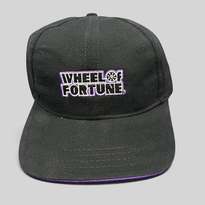 Raree Finds vintage black snapback hat with purple brim and embroidered Wheel of Fortune logo by Competition Headwear