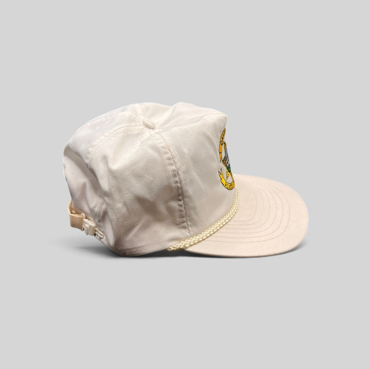Raree Finds vintage 90s white Otto snapback hat with California State Parole emblem and braided rope brim detail.