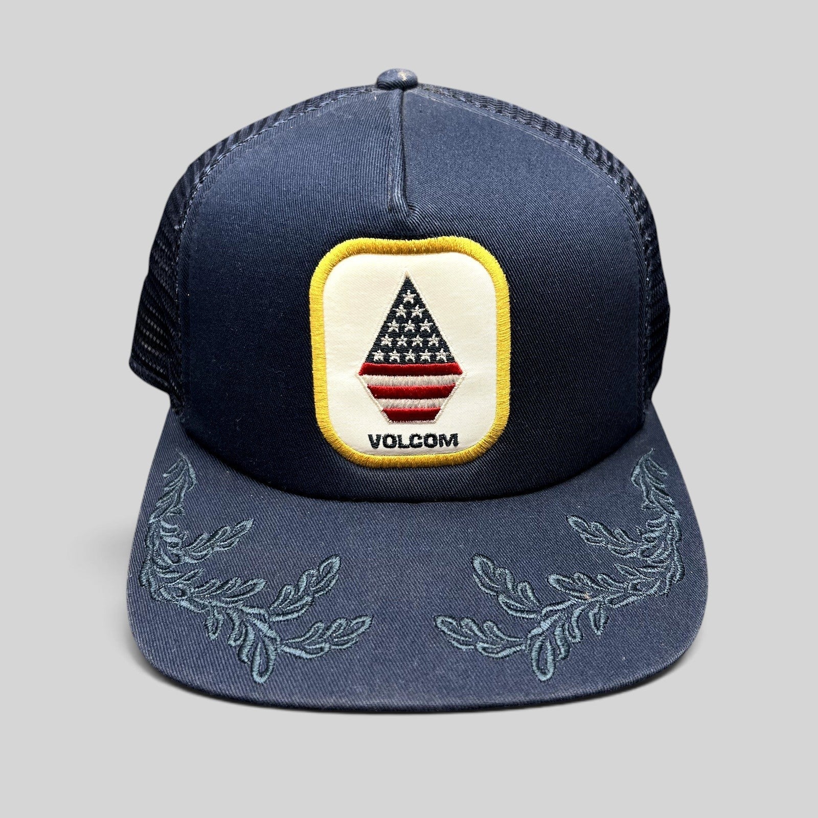 Raree Finds Volcom x New Era navy trucker snapback hat with USA flag stone logo patch and embroidered brim detail