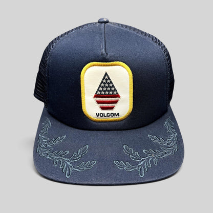 Raree Finds Volcom x New Era navy trucker snapback hat with USA flag stone logo patch and embroidered brim detail
