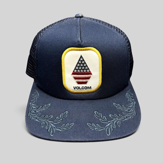 Raree Finds Volcom x New Era navy trucker snapback hat with USA flag stone logo patch and embroidered brim detail