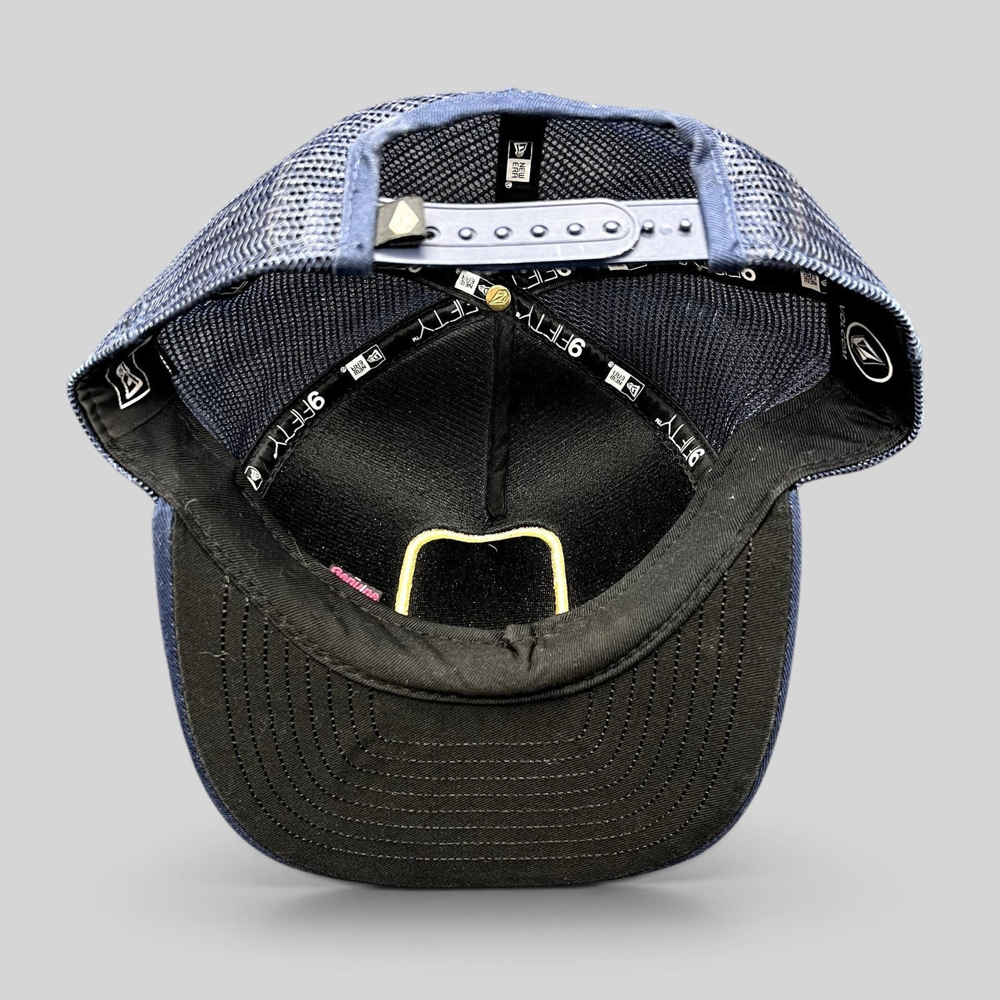 Raree Finds Volcom x New Era 9FIFTY trucker hat interior showing mesh backing, snapback closure, and branded taping.