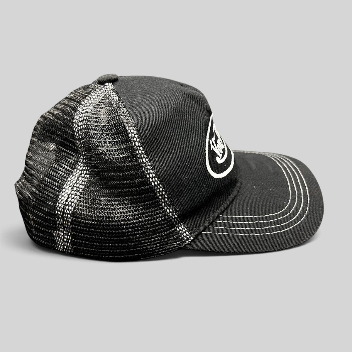 Raree Finds vintage Von Dutch black and white trucker hat with mesh back, curved brim, and embroidered logo.
