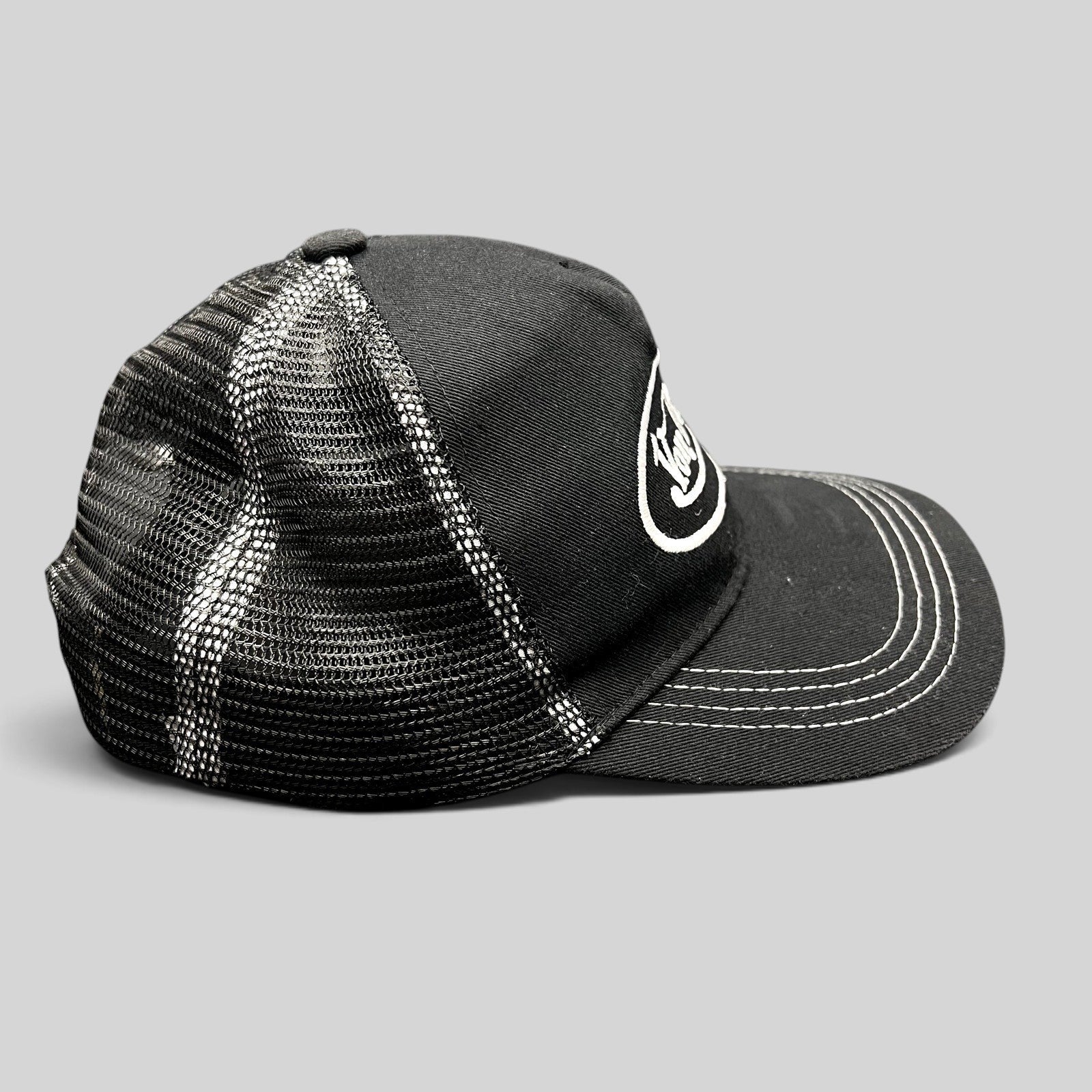 Raree Finds vintage Von Dutch black and white trucker hat with mesh back, curved brim, and embroidered logo.