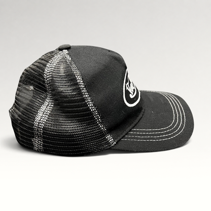 Raree Finds vintage Von Dutch black and white trucker hat with mesh back, curved brim, and embroidered logo.
