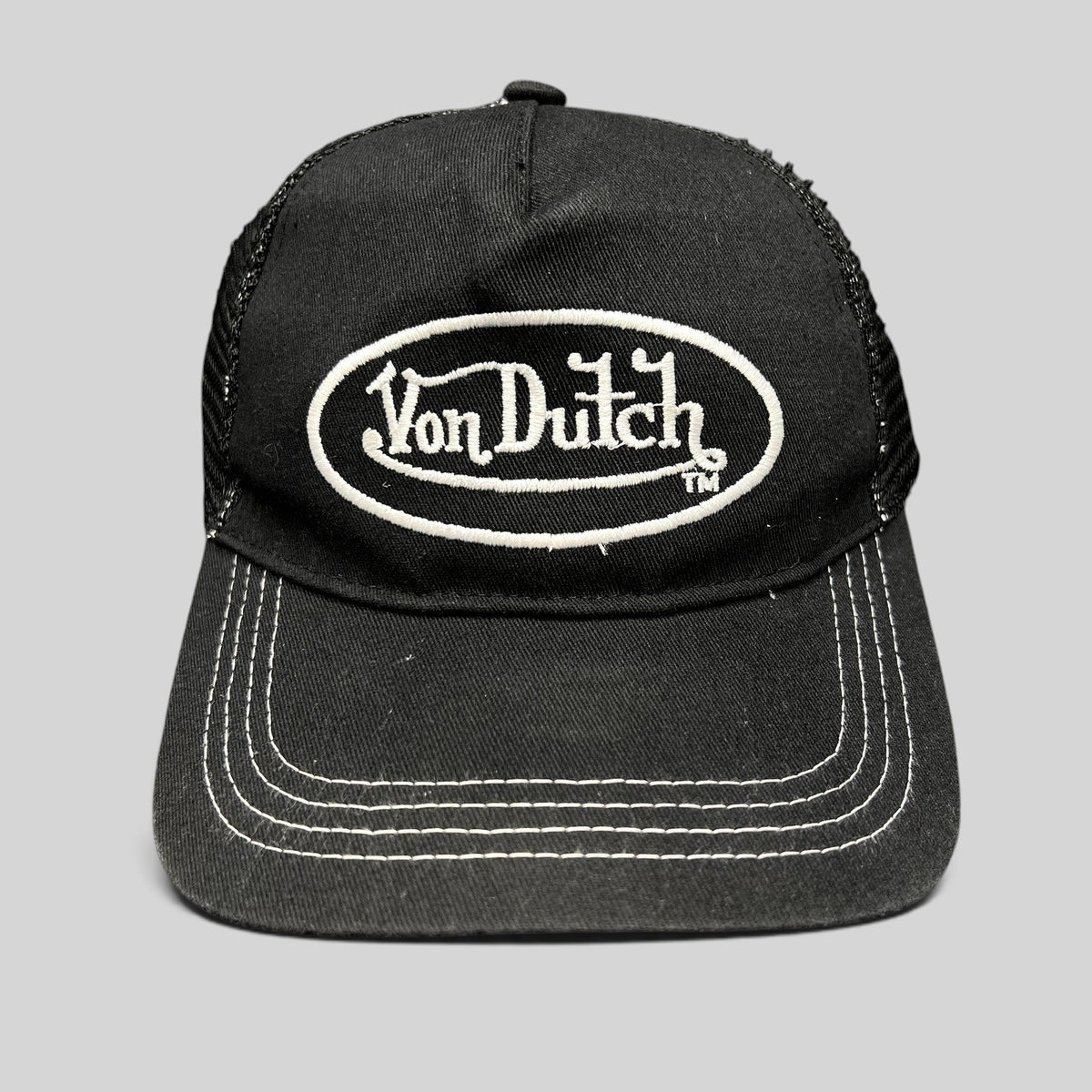 Raree Finds vintage Von Dutch black and white trucker hat with embroidered oval logo and contrast stitching.