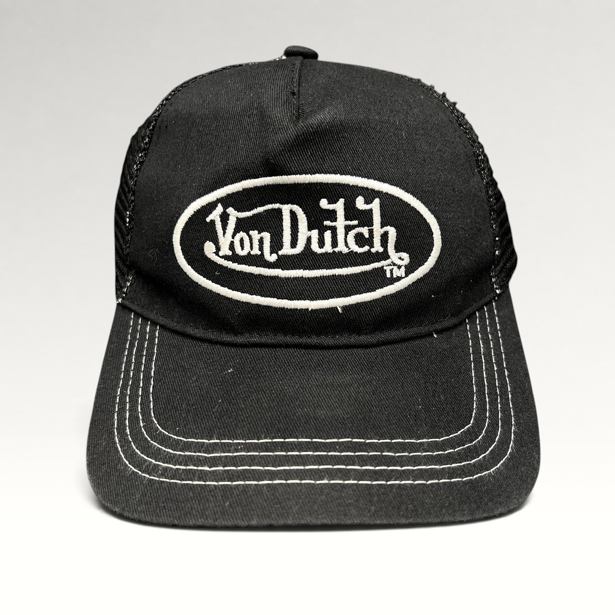 Raree Finds vintage Von Dutch black and white trucker hat with embroidered oval logo and contrast stitching.