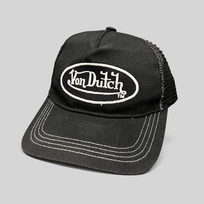 Raree Finds vintage Von Dutch black trucker hat with white oval logo embroidery, mesh back, and contrast stitching.