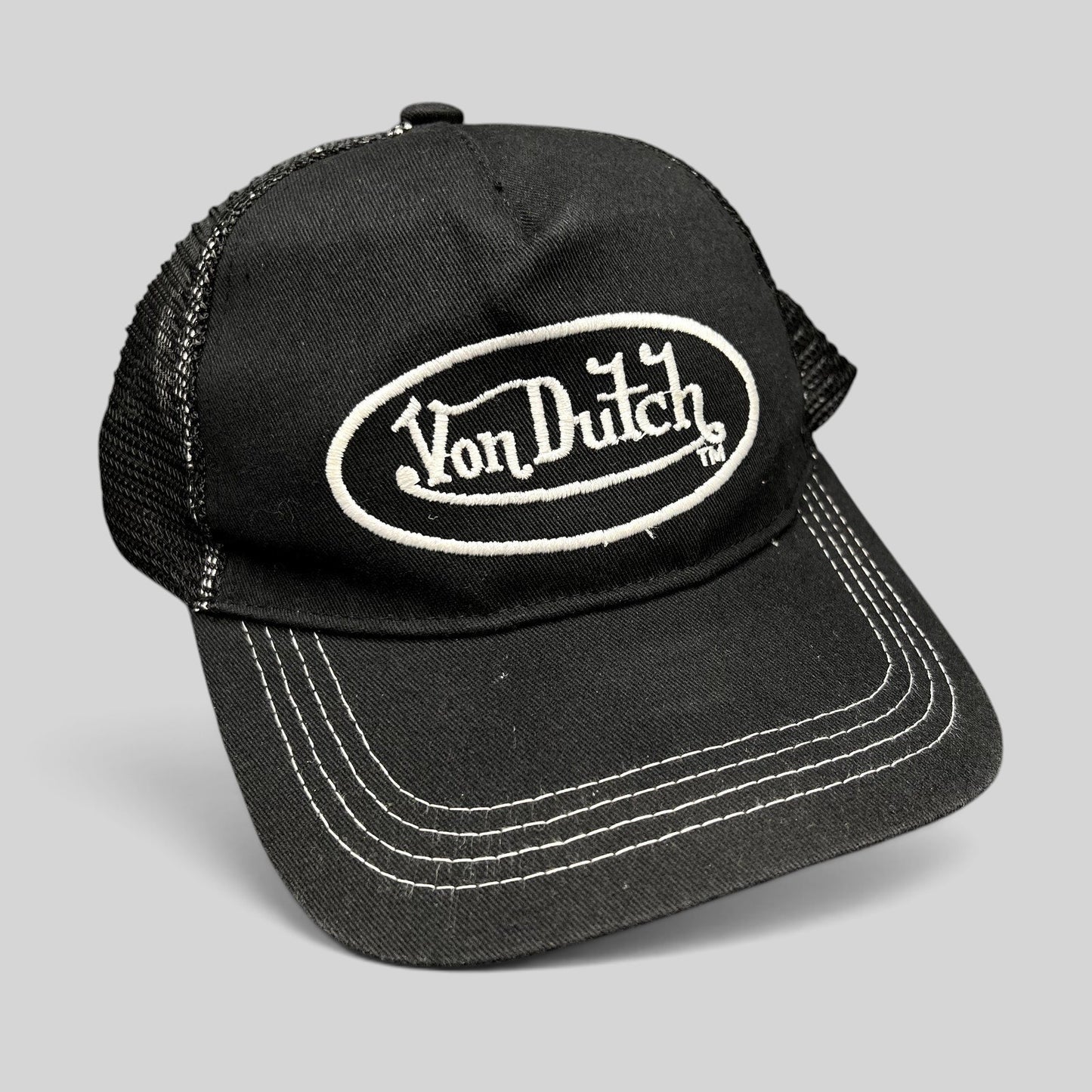 Raree Finds vintage black and white Von Dutch trucker hat with embroidered oval logo and mesh back panels.
