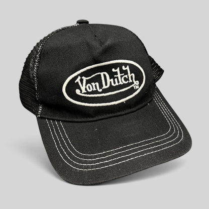 Raree Finds vintage black and white Von Dutch trucker hat with embroidered oval logo and mesh back panels.