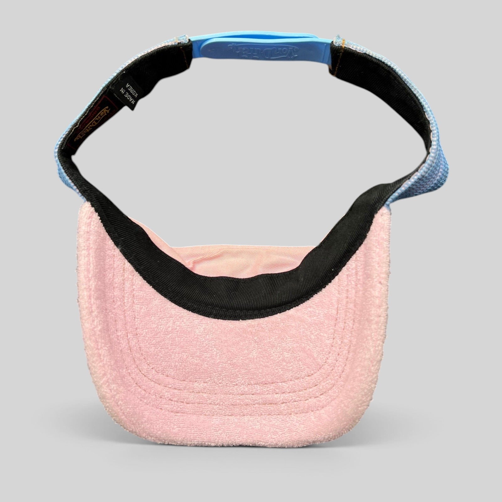 Raree Finds vintage Von Dutch Y2K pink terry cloth visor with a blue strapback closure and black trim.