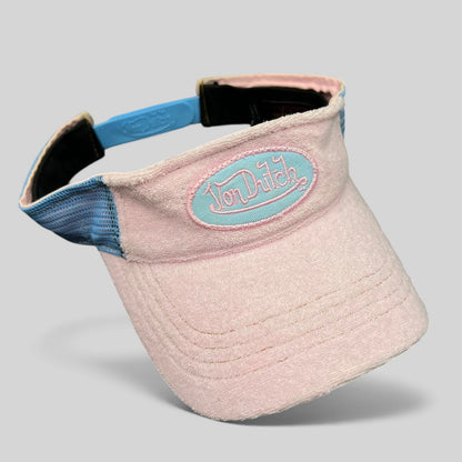 Raree Finds vintage Von Dutch Y2K pink and blue terry cloth visor with an oval logo patch and plastic strapback.