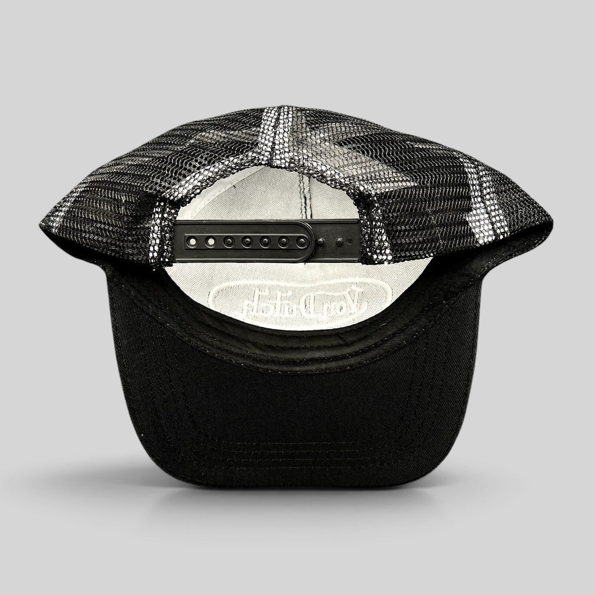Raree Finds vintage Von Dutch black and white trucker hat showing the adjustable snapback closure and mesh back panel
