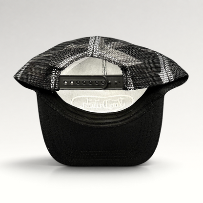 Raree Finds vintage Von Dutch black and white trucker hat showing the adjustable snapback closure and mesh back panel
