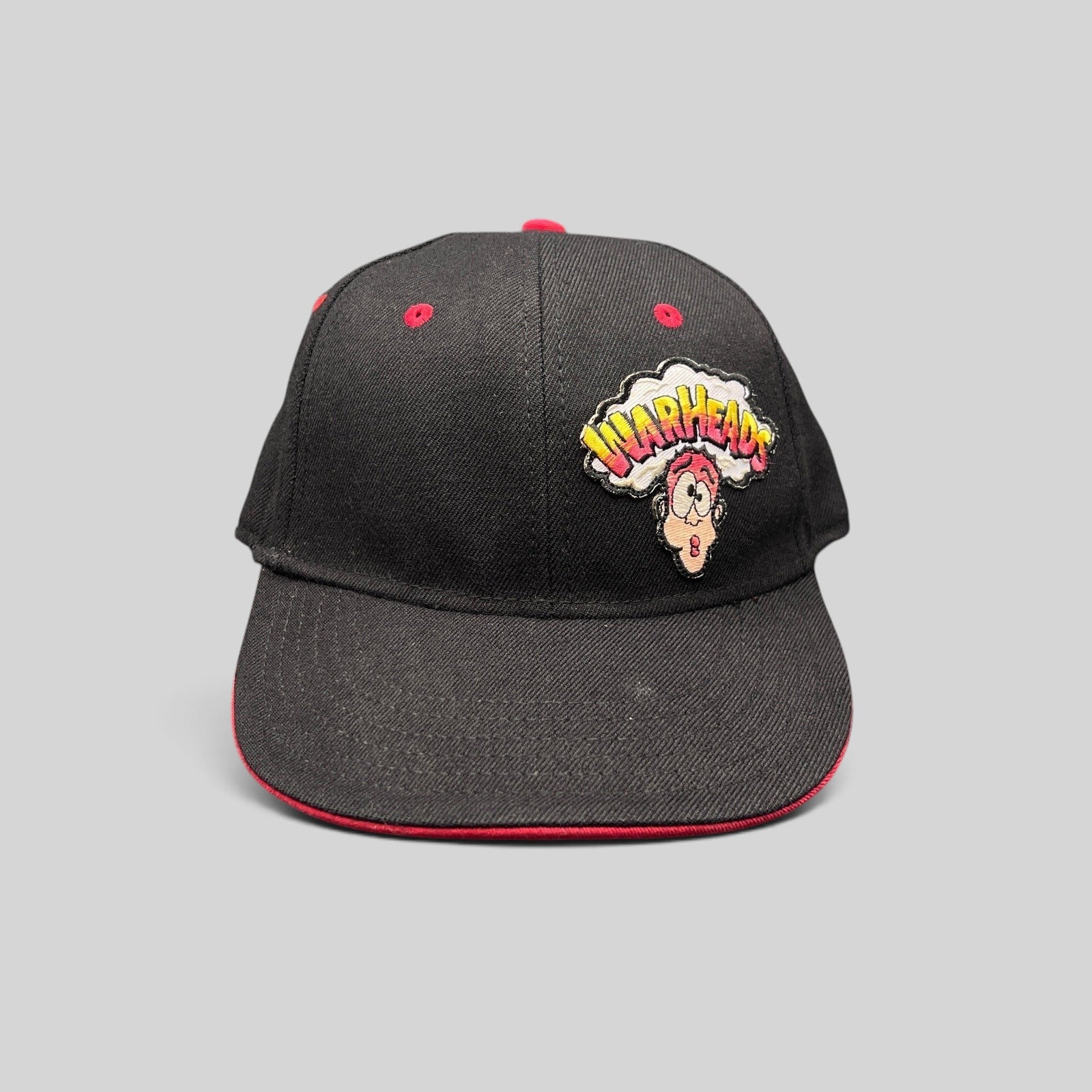 Raree Finds vintage Y2K Warheads candy promo hat with black crown, red brim, and embroidered logo on Otto Flex base