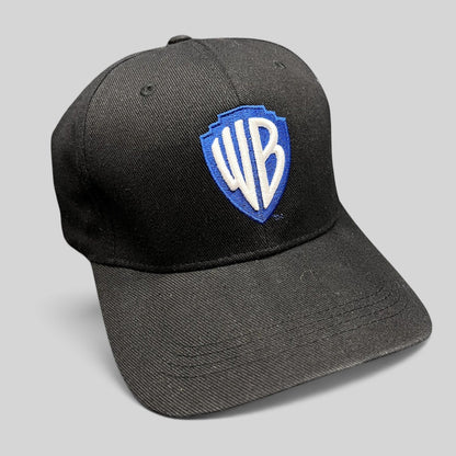 Raree Finds black fitted hat featuring an embroidered blue and silver WB shield logo from Warner Bros Studio Tour